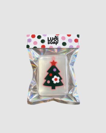 Savon sapin de Noël Ludi Soap transparent avec décoration verte et emballage holographique.